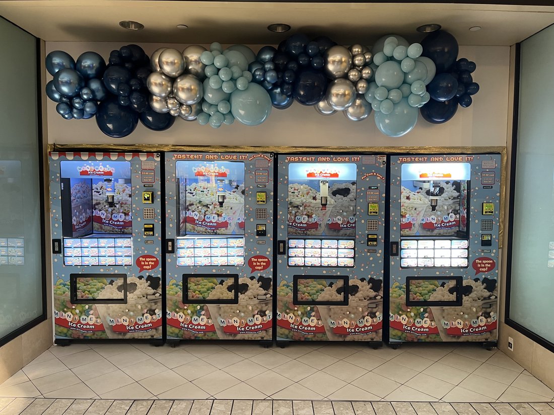 Four Mini Melts vending machines with balloon decor at Stamford Town Center